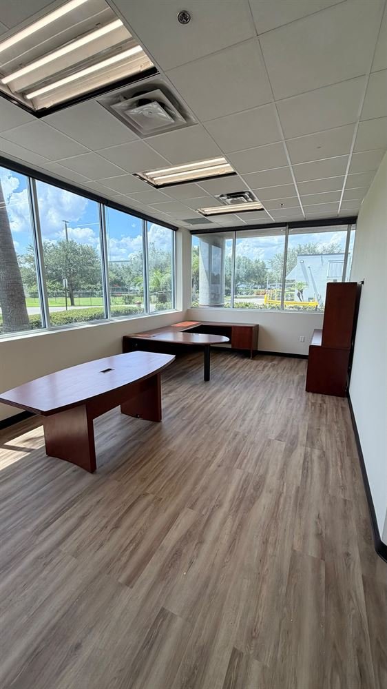 Renovated conference room with wood flooring and natural light