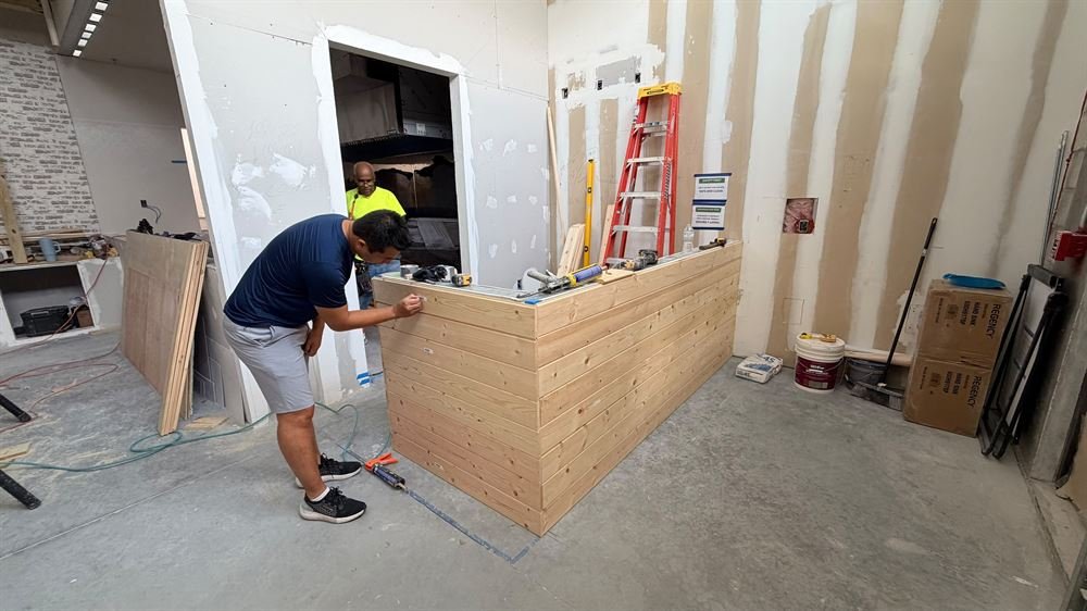 Crew framing and building a service counter on site