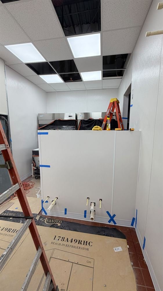 Drywall and suspended ceiling grid installation in progress