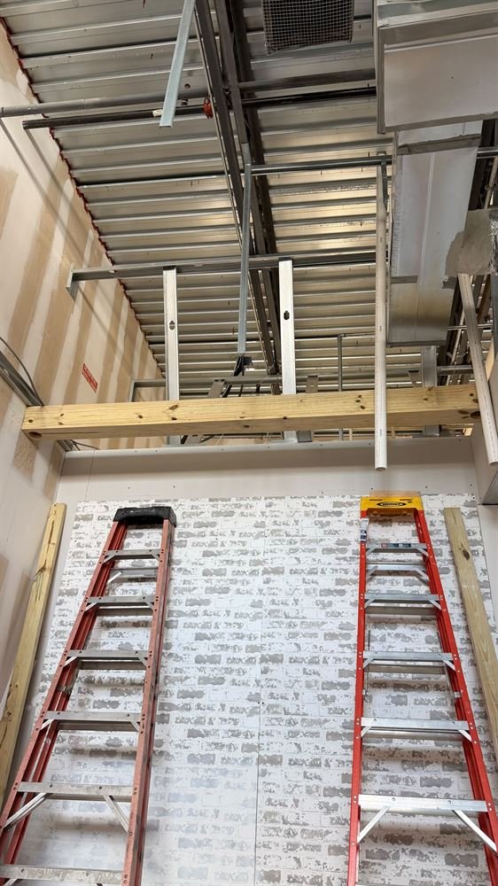 Large commercial space with exposed steel framing during build-out