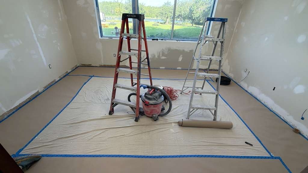 Room prepped and floors protected before painting